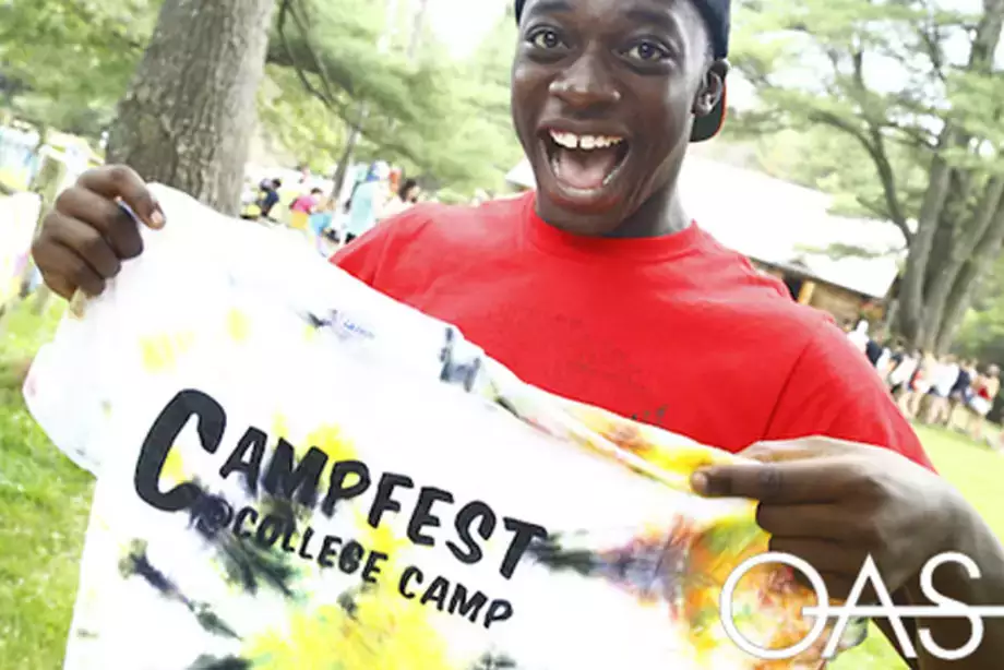 Student holding Campfest t-shirt