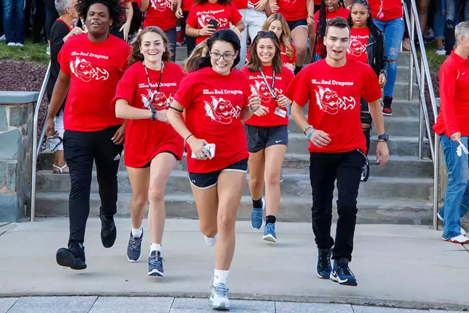 Students running between Old Main pillars