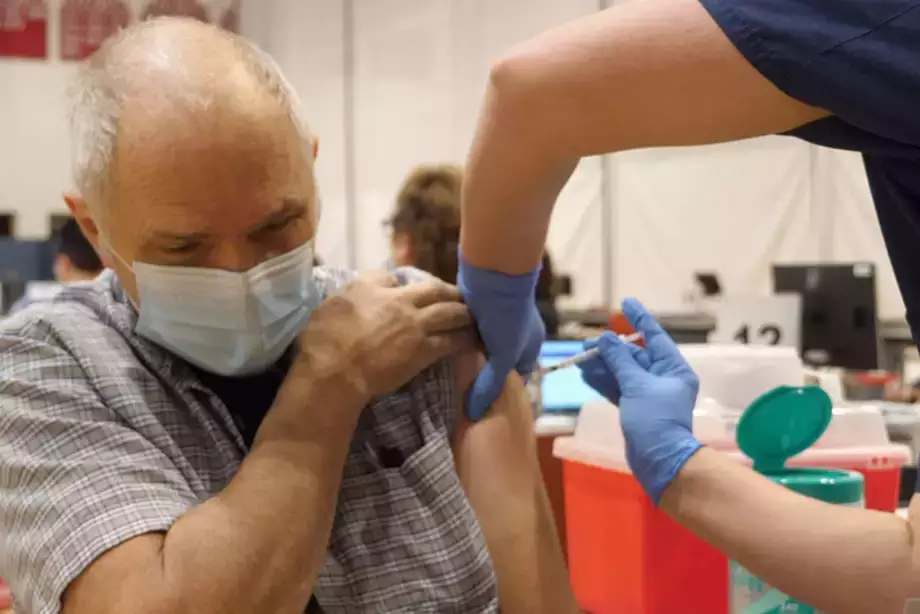 Community member getting COVID shot at state vaccination center on SUNY Oneonta campus