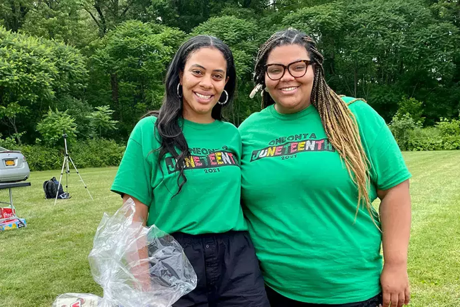 Sierra Sangetti-Daniels, left, and her sister, event creator Diandra Sangetti-Daniels, stand near the raffle basket table during the Juneteenth event.
