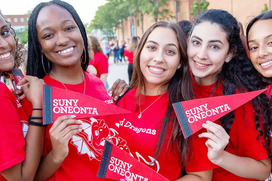 Students Holding SUNY Oneonta Pennet