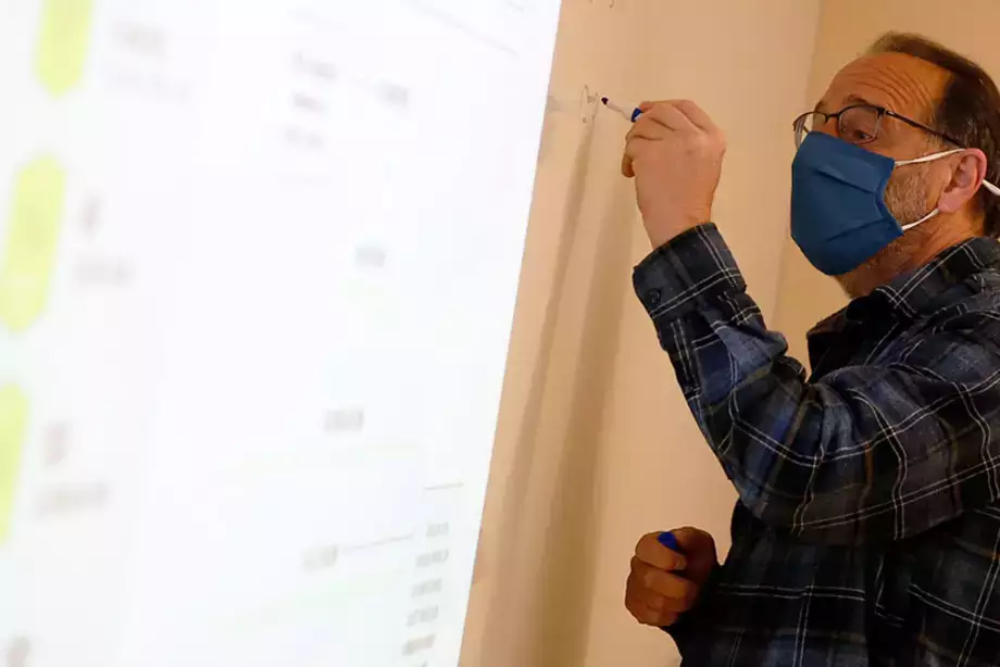 Professor working with students during lesson