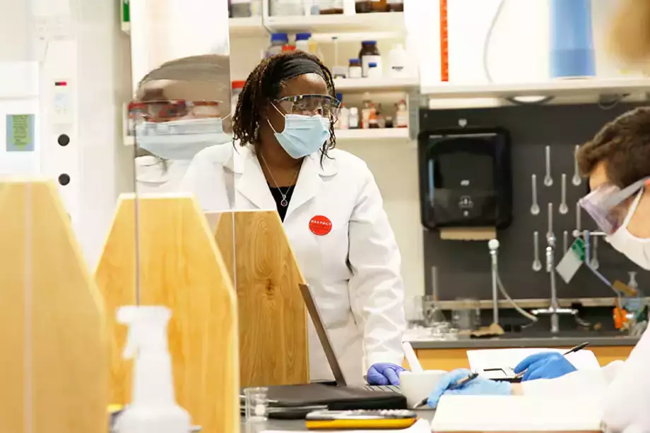Professor working with students to test different materials.