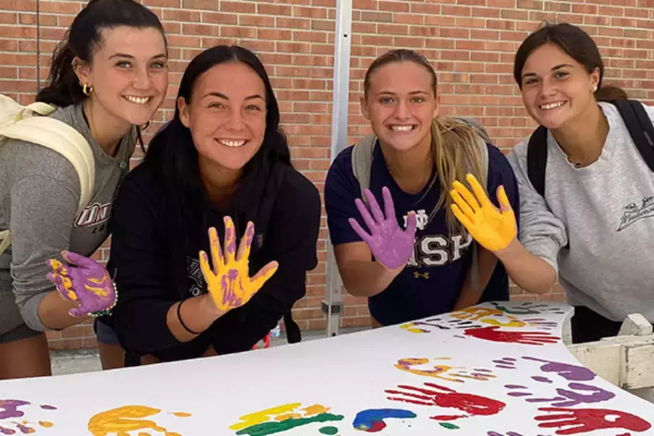 Students Place Painted Hand Prints on the WIngs