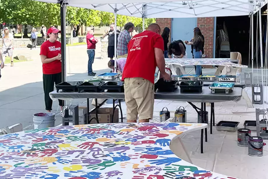 Students Place Painted Hand Prints on the WIngs