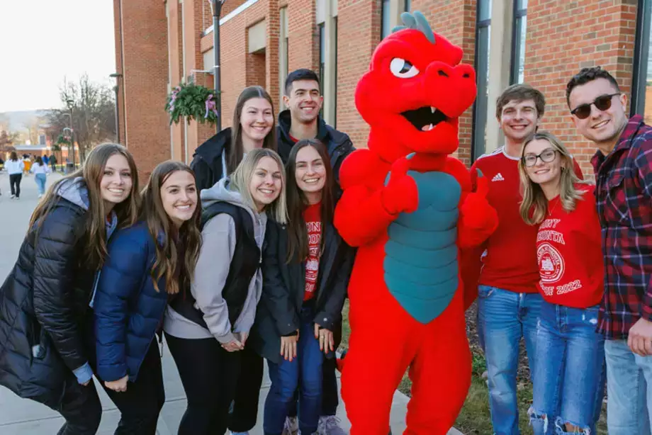 Students taking a picture with Red the Dragon