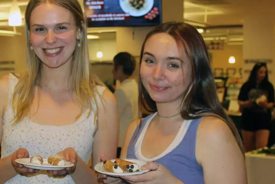 Two Students showing their food.
