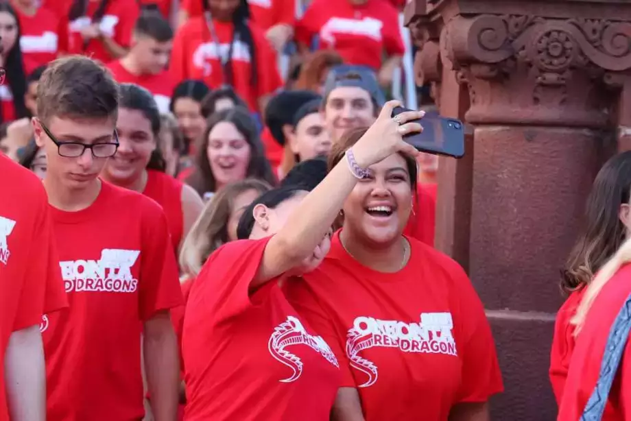 Two students smiling while taking a selfie together at the Pass Through the Pillars event.