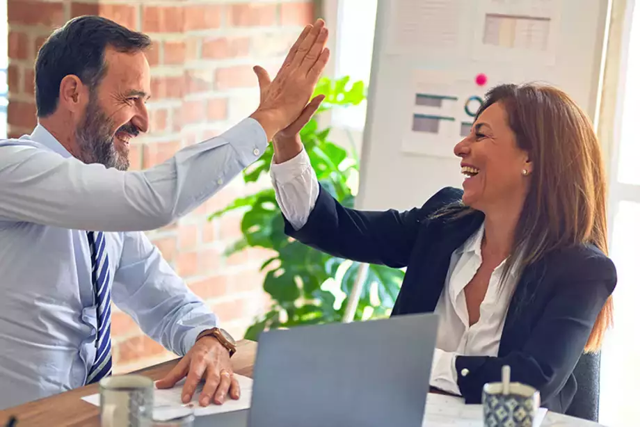 Colleagues "high-fiving" eachother