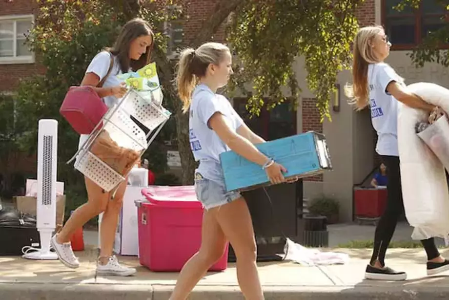 Students carrying goods on move in day.