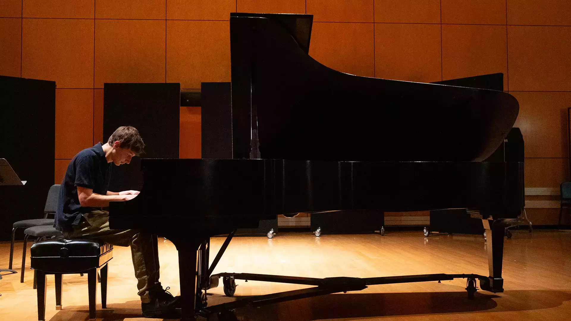 A music major student plays a grand piano as part of the 2024 fall concert