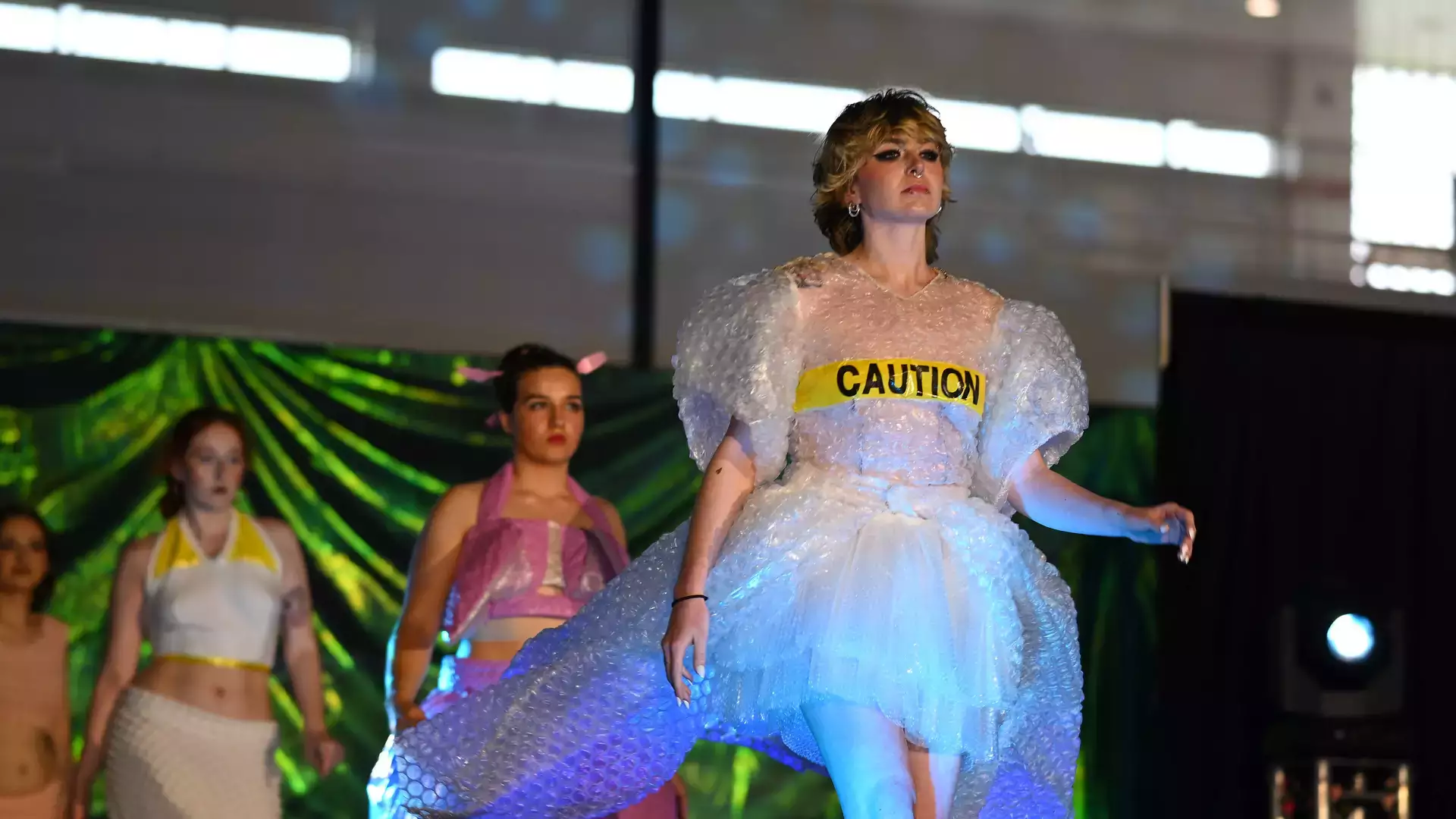 Student models and designers participate in the annual fashion show.