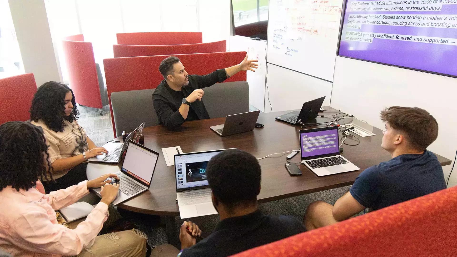 Students learning hands-on as they prep for the pitch competition.