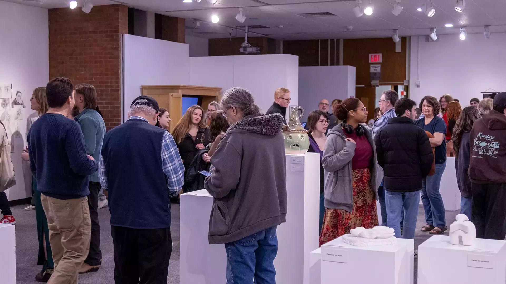 Patrons and students mingle during the juried student art show.