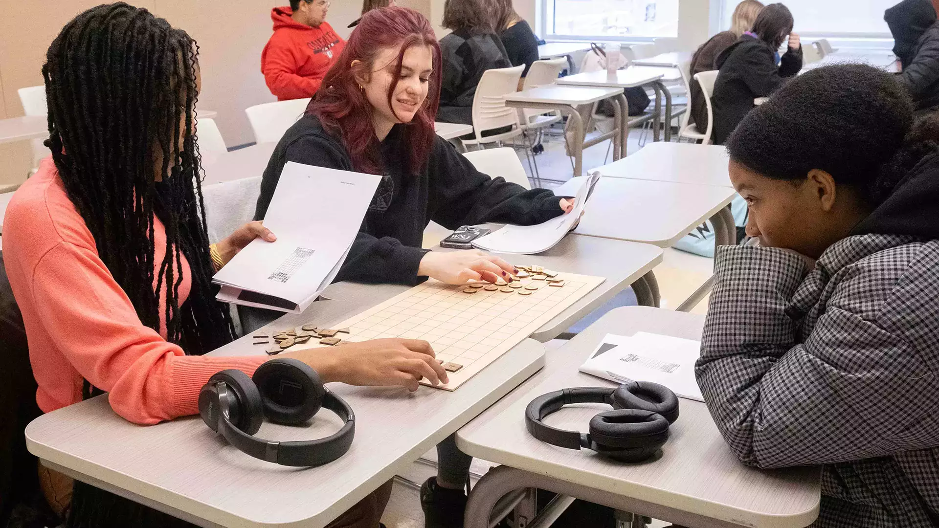 Students play Rithmomachia, a medieval mathematics board game