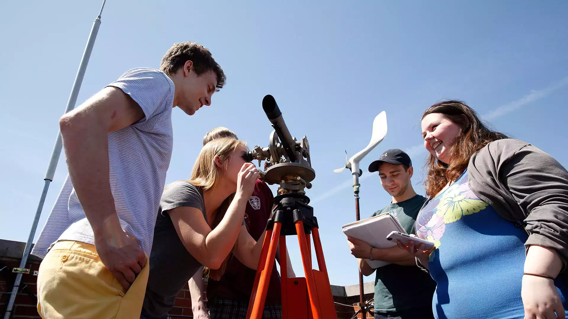 Meteorology students in a senior seminar learn how to use a theodolite