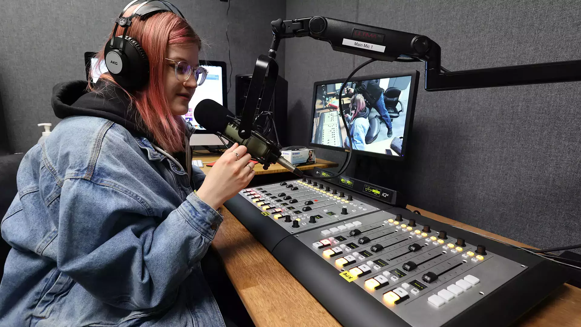 A student works the soundboard at 90.9 FM, WONY