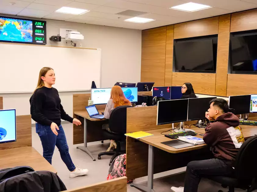 Accounting students discuss the subject in one of the high-tech business school rooms.