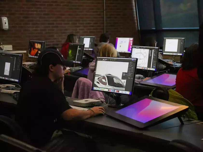 Students utilizing digital tools as part of their graphics class.
