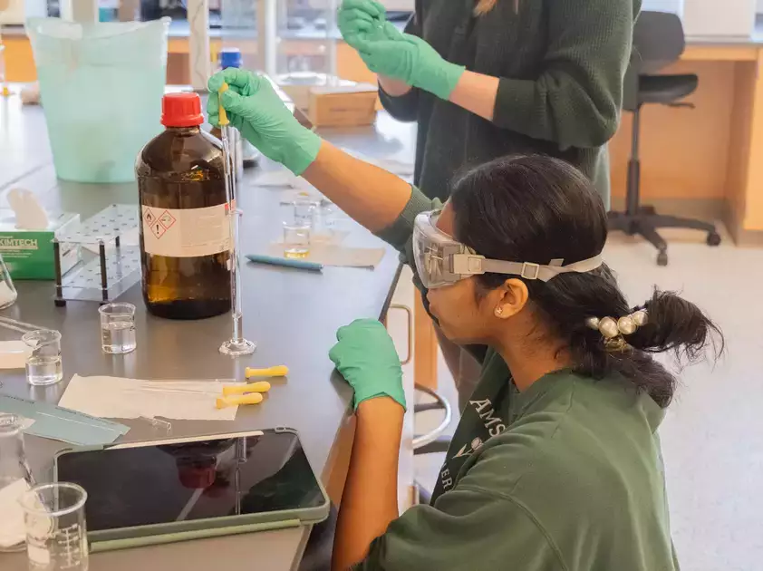 An organic chemistry student works with solutions in the lab.