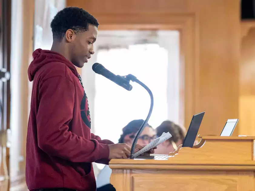 An English major reads prepared material at the Common Read Conference.