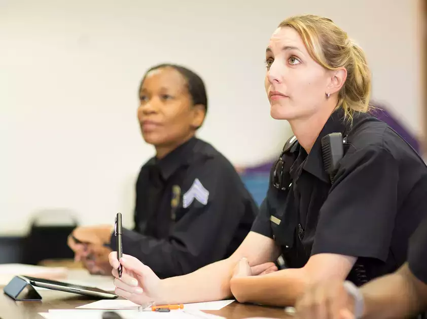 Students listen intently during a law enforcement academy class